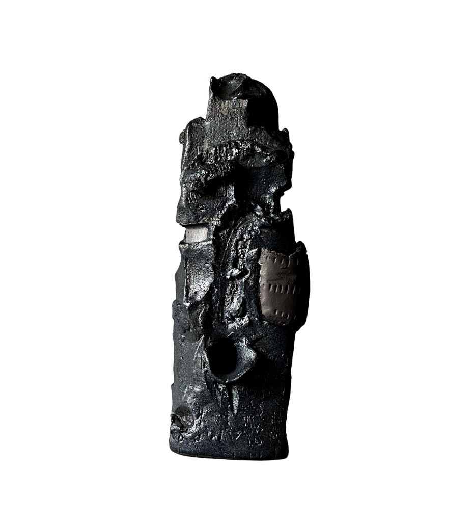 Black stoneware sculpture, Chronolith 01, tall irregular vertical form with incised geometric marks and variegated glaze treatments.
